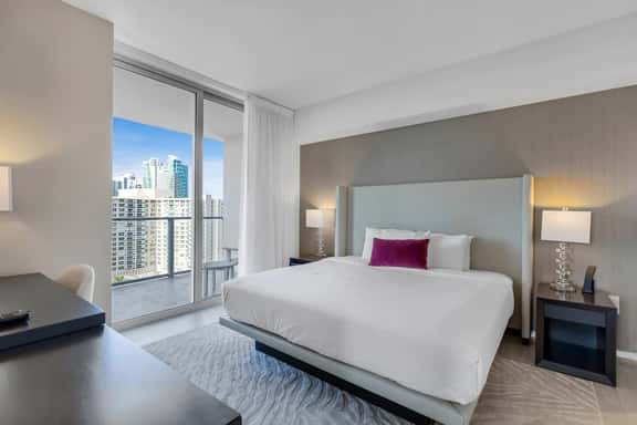 Step into the master bedroom, featuring a plush king-size bed, private bathroom, and direct access to the balcony. A dedicated workspace adds comfort and convenience.