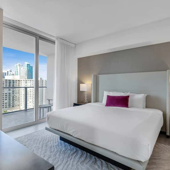 Step into the master bedroom, featuring a plush king-size bed, private bathroom, and direct access to the balcony. A dedicated workspace adds comfort and convenience.